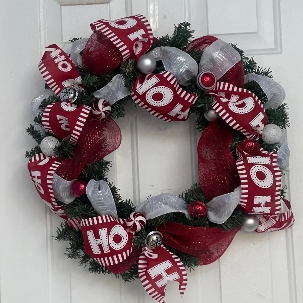 Handmade Christmas wreath, ribbon,bells, and ornaments. Silver, white and red